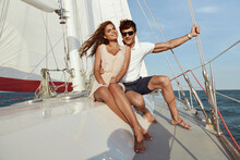 Young Romantic Couple Resting On Yacht In Sea