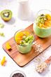 Matcha overnight oatmeal and fruits in glass, rich in protein breakfast or snack