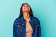 © Asier - Young latin woman isolated on blue background relaxed and happy laughing, neck stretched showing teeth.