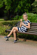 Teen girl eating ice cream on bench in park