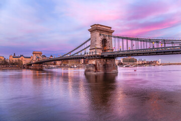 Fototapete - Badapest with famous chain bridge against colorful sunset in Hungary