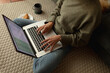 © Wavebreak Media - Caucasian woman in living room, sitting on floor, working using laptop