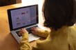 © Wavebreak Media - Caucasian woman in living room sitting at table, working using laptop