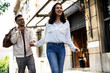 © JustLife - Happy young couple outdoors. Loving boyfriend and girlfriend walking in the city..