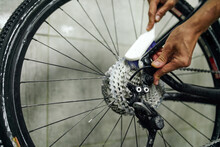 Crop Man Cleaning Gear Cassette Of Bike Wheel