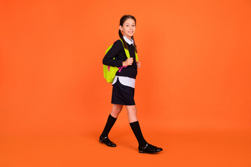 Sticker - Full length photo of pretty cute small schoolgirl go school wear backpack isolated on orange color background