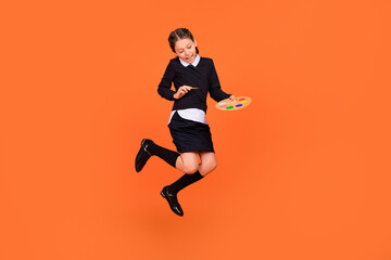 Poster - Full length body size view of pretty cheerful preteen girl jumping drawing design craft isolated over bright orange color background