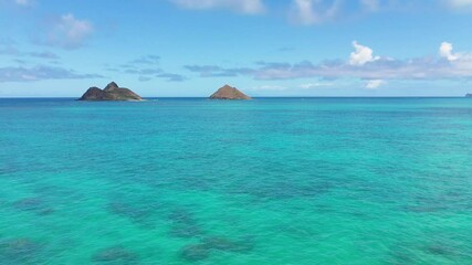 Wall Mural - Aerial view of the twin Mokulua Islands off the coast of Lanikai beach in Oahu, Hawaii, with turquoise water and visible coral reefs in the foreground.