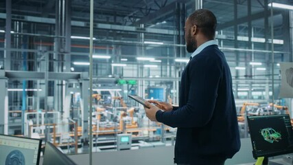 Fototapete - Car Factory Office: Portrait of Successful Black Male Chief Engineer Using Tablet Computer in Automated Robot Arm Assembly Line Manufacturing High-Tech Electric Vehicles. Arc Side View Medium Shot