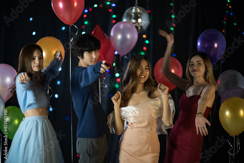 Portrait of asian friends, new year party, new year\'s gift, nightlife on holiday, happy and enjoy group of friends, lifestyle concept, balloon backdrop.fancy night.