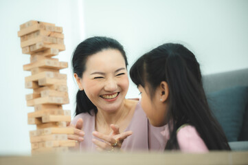 children development education, mother and daughter family playing and learning fun at home, young woman and eltern teacher are happy smiling together, little cute girl childhood concept