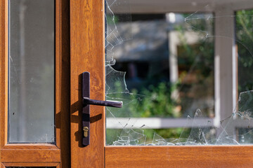 Modern door with handle and broken glass.