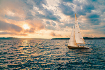 Wall Mural - Sailing yacht in a calm sea and an incredible sunset.