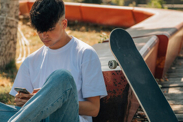 Poster - teenage boy with mobile phone and skateboard on the street