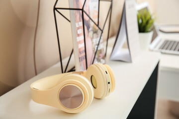 Wall Mural - Modern headphones on shelf in room, closeup