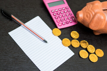 Poster - Closeup of calculator, coins, and cashbox on a gray table