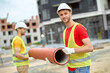 © zinkevych - Two construction workers in hardhats posing for the camera outdoors