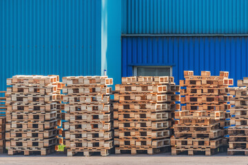 Pile of old wooden pallet by the plant.