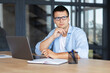 © kucherav - Business serious caucasian man with glasses sitting in the office thinking about future plans