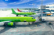 © orelphoto - Passenger planes at airport near boarding terminal
