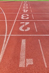 Wall Mural - The curved lane in running track or athlete track in stadium. Running track is a rubberized artificial running surface for track and field athletics