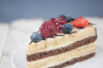 Canvas Print - Mix berry cheese cake on white plate on wood background