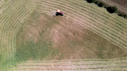 Poster - An aerial view of a tractor mowing the green vetch