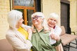 © zinkevych - Three ssweet senior ladies looking happy spedning time together