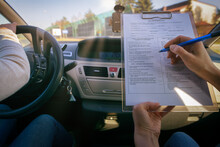 Examiner Filling In Driver's License Road Test Form