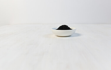 Canvas Print - Bowl with Nigella seeds spice on white background