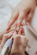 © Aldana - Manicurist , hands closeup. Professional manicure in beauty salon. Hygiene and care for hands. Beauty industry concept.