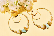 Close Up Image Of Handmade Modern Earrings On Mirror Background