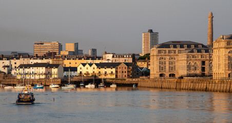 Wall Mural - Plymouth, Devon, England, UK. 2021. The Royal William Yard a Grade 1 listed site formerly Royal Navy victualling bulidings and waterfront homes on the River Tamar, Plymouth. Evening light,