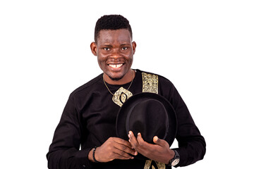 handsome young man holding his hat smiling.