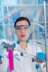 Wall Mural - Young woman in a pharmacological laboratory. Development of an antiviral drug. Pandemic COVID-19