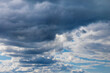 Light and dark clouds on blue sky. Colorful cloudscape background.