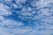 White tiny clouds over blue sky background. Beautiful view of natural scene at sunny day.