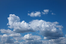 White Flocky Clouds Over Blue Sky Background. Beautiful View Of Natural Scene At Sunny Day.
