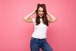 © Ivan Traimak - Photo portrait of young beautiful smiling hipster brunette woman in white t-shirt with mockup. Sexy carefree female person posing isolated near pink wall with empty space in studio. Positive model