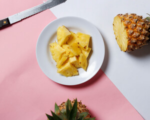 Whole pineapple isolated on a bright background. Close-up view of fresh and delicious pineapple. Overripe pineapples that begin to rot will release a sweet, honey-like liquid. Focus blur. Pineapple mo