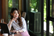© Prathankarnpap - Thoughtful businesswoman sitting in modern office and looking out of window.