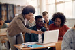 Leinwandbild Motiv African Americans college students and their teacher use laptop during computer class.