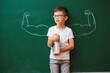 © Serhii - Cute child boy in school uniform and glasses. Go to school for the first time. Child with school bag and books. Kid in class room near chalkboard with muscles on it. Back to school