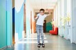 © Serhii - happy boy in school corridor. Back to school.