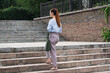 A beautiful and attractive Caucasian business woman is walking up the steps. Back view.