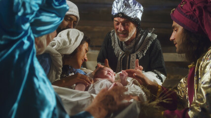 Magi and parents speaking over manger with baby Jesus