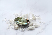 Clear Quartz Minerals, White Sage Bundle On Abalone Sea Shell. Incense For Fumigation, Cleansing, Good Energy. Healing Crystals. Wiccan Witchcraft. Esoteric Spiritual Practice Concept. 