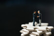 Miniature business man shake hand partner client customers on white Jigsaw Puzzle with success dealing business using as contract commitment agreement investment and partnership business development