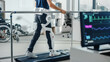 © Gorodenkoff - Modern Hospital Physical Therapy: Patient with Injury Walks on Treadmill Wearing Advanced Robotic Exoskeleton Legs. Physiotherapy Rehabilitation Technology to Make Disabled Person Walk. Focus on Legs