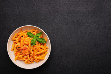 Plate CHERRY TOMATO PASTA Like an Italian on dark background with copy space